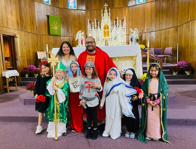 Photo of the kids along with the priests of the school taking a picture, the students dressed up as characters from the bible