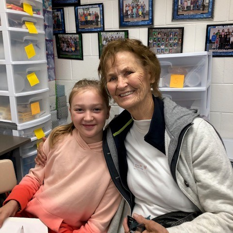 A student and her grandparent visits in class for Grandparents Day