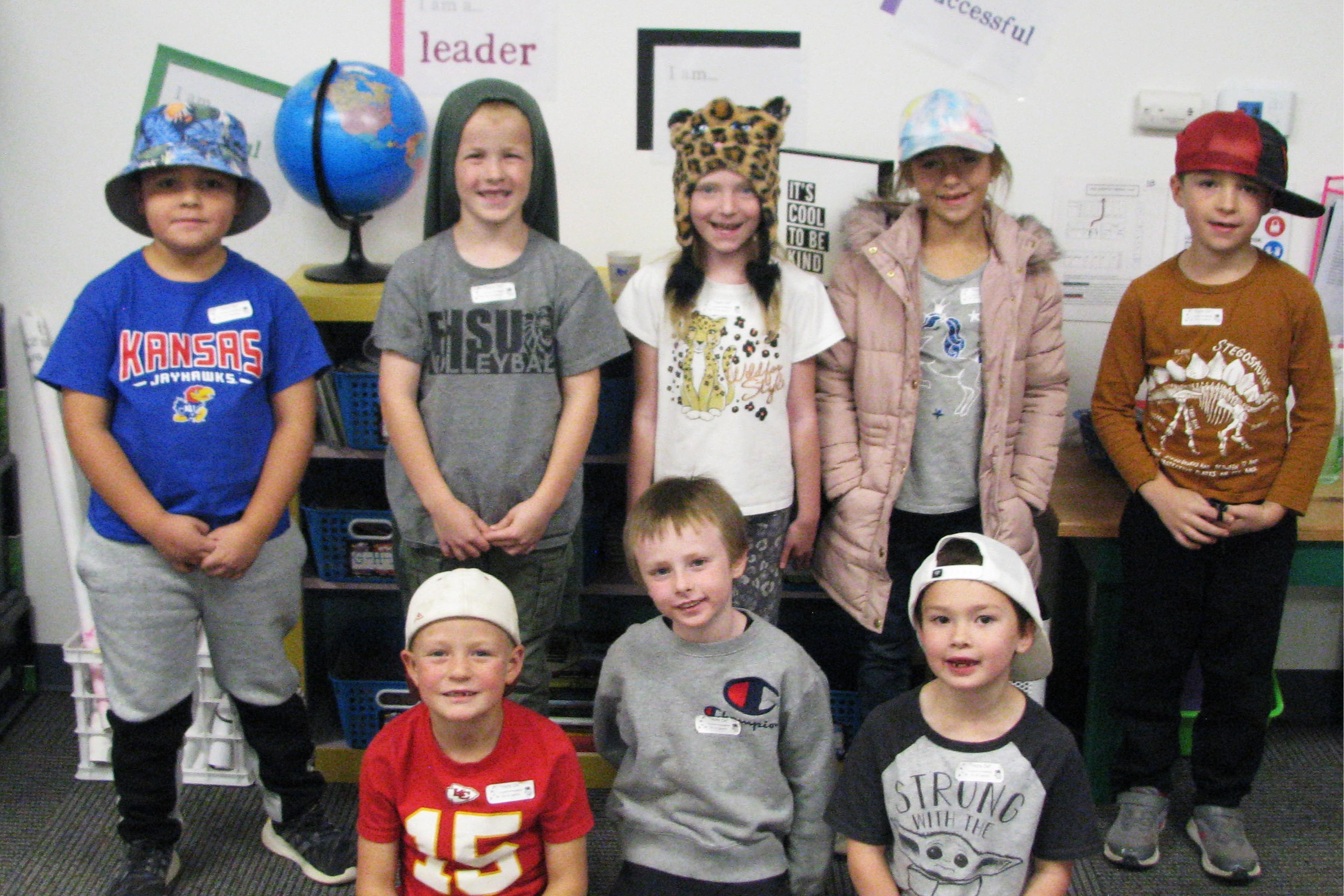 Students with good attendance gather for picture wearing hats for hat day