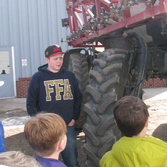  Students gathered around a tractor for BARN YARD AND FARM SAFETY DAY