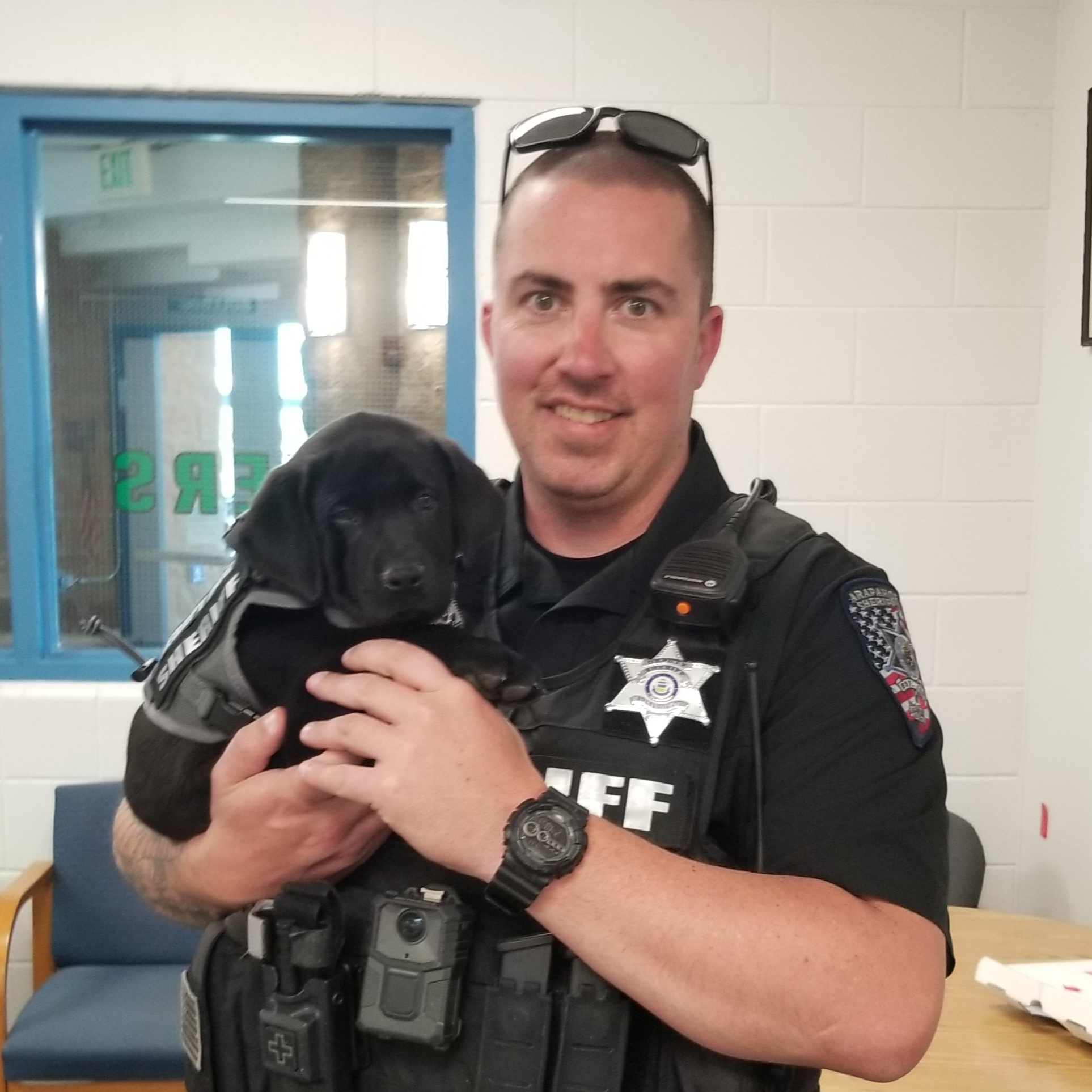 Officer Drew Mathews with K9 SRO puppy Otis