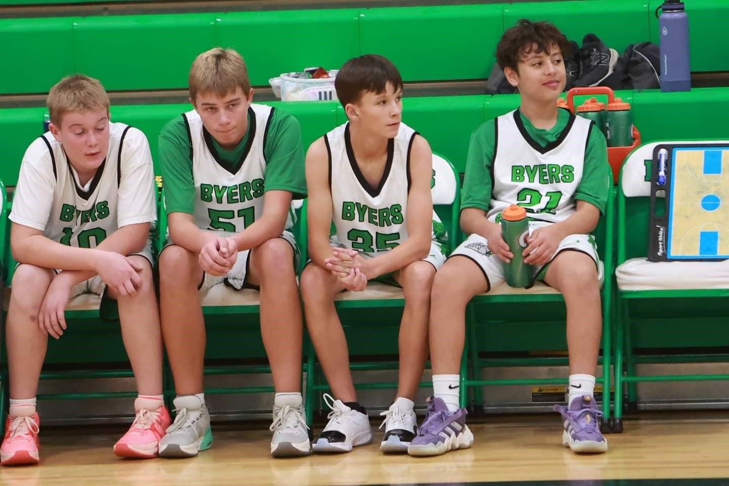 Byers team on the bench cheering on the boys on the court