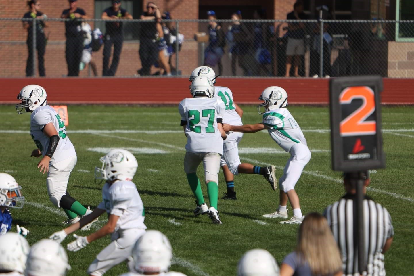 Byers JH football wearing white unifroms getting ready to play.