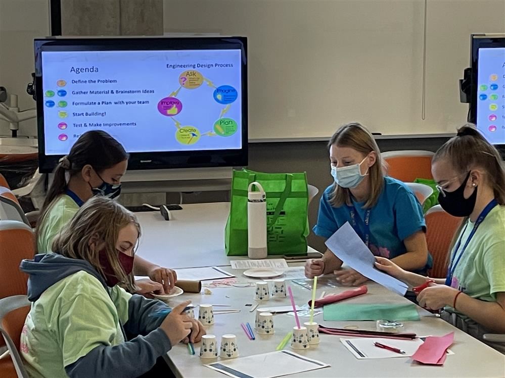 students at a presentation doing crafts