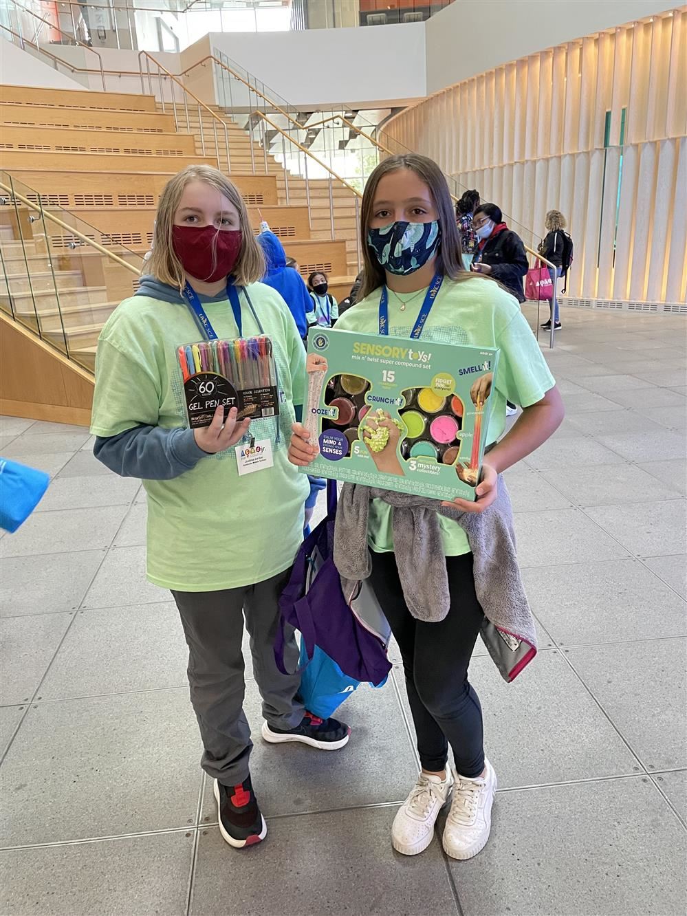 two students with supplies