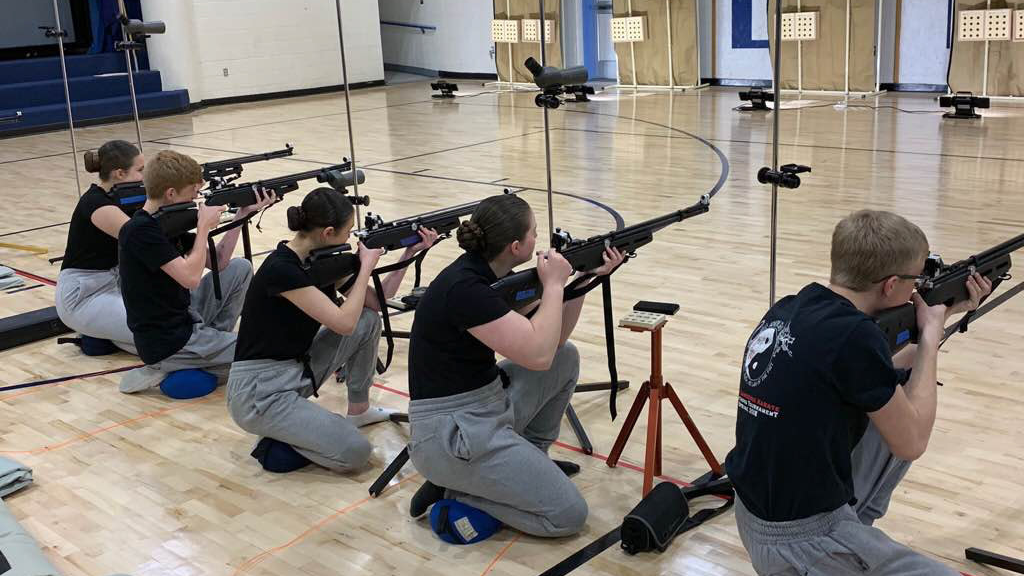 high school naval jrotc cadets in air rifle competition