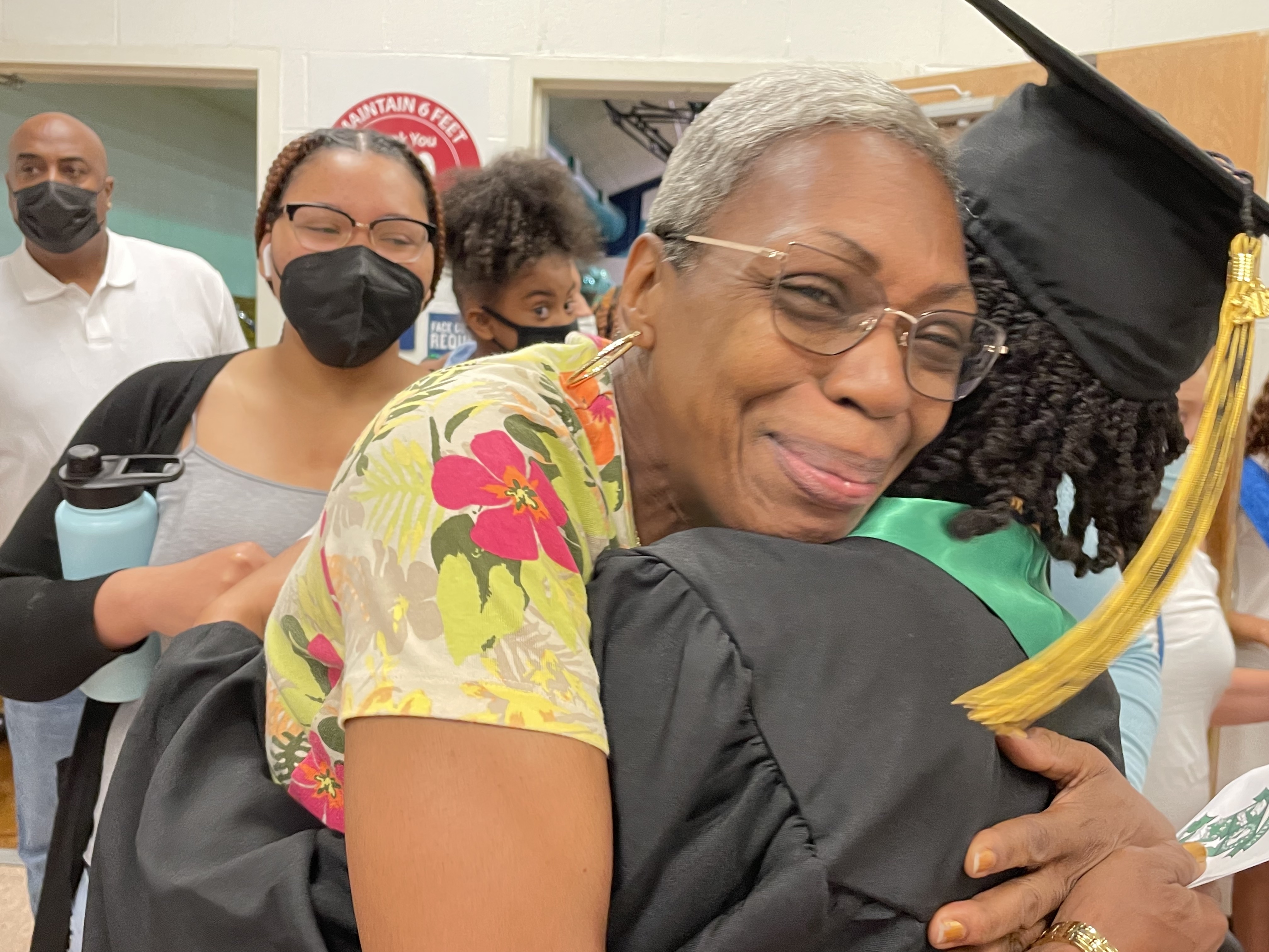 woman hugging a recent graduate