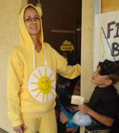 a teacher dressed in yellow with a sunshine image on the front of her hoodie