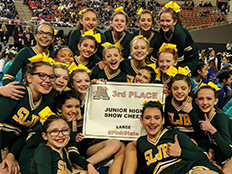 the SLJHS cheerleading team holding a third-place award and smiling