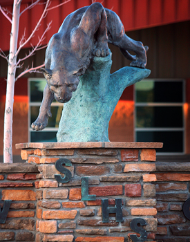 a statue of a cougar outside Show Low High School