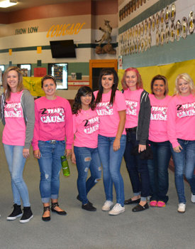 A group of female students and teachers in pink shirts