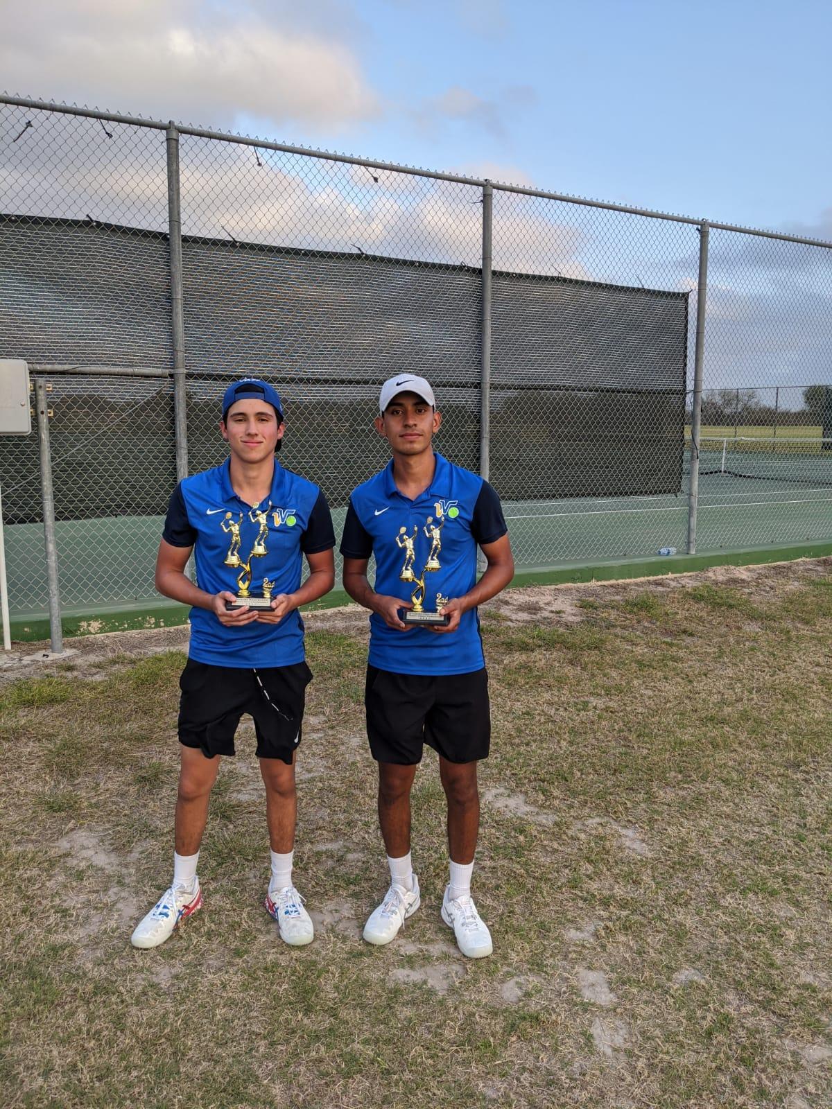 two tennis players holding 2 trophies