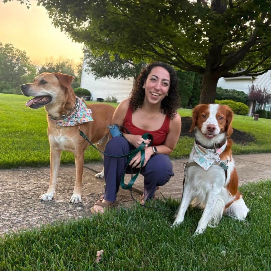 Women smiling at camera with 2 dogs
