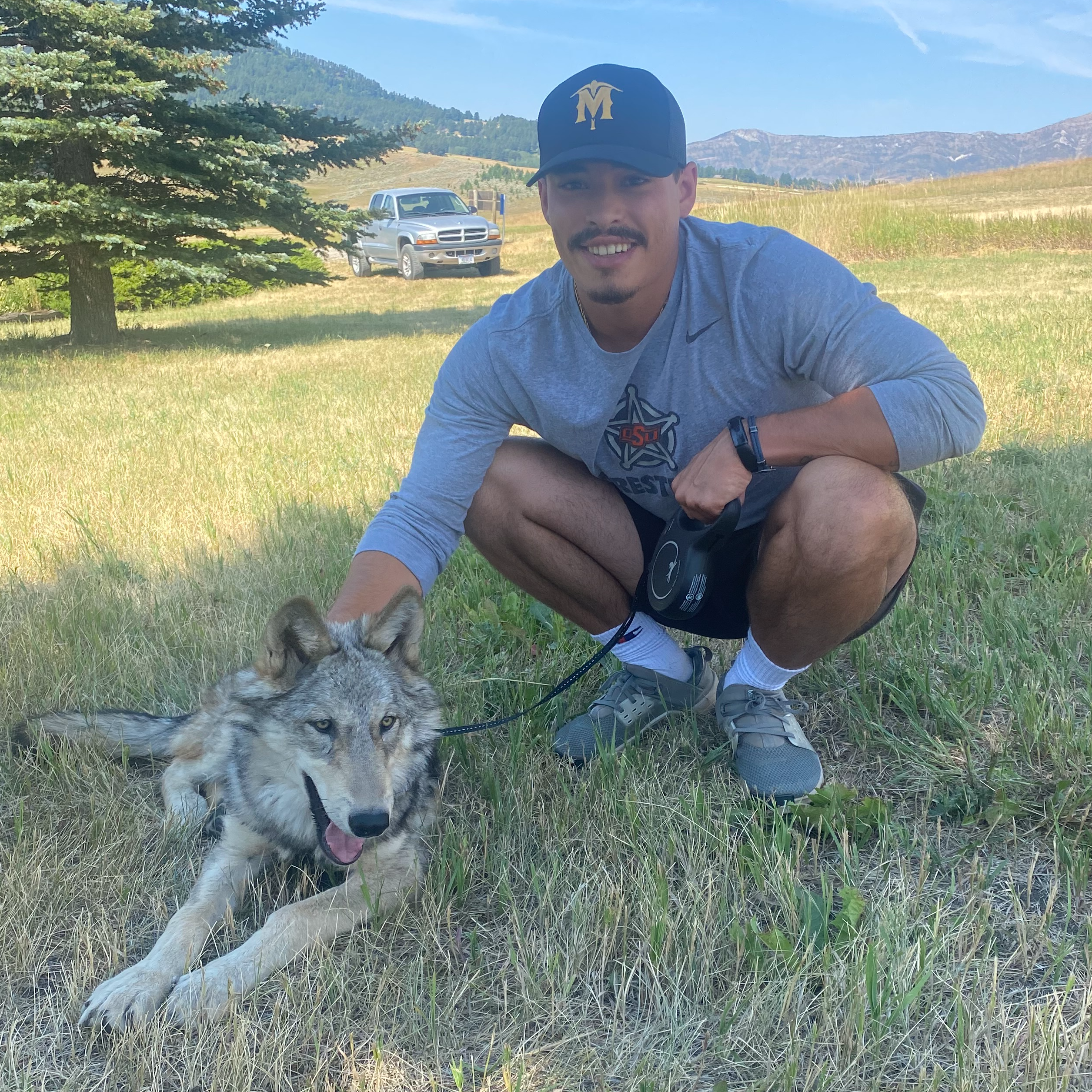 white male smiling at the camera with dog