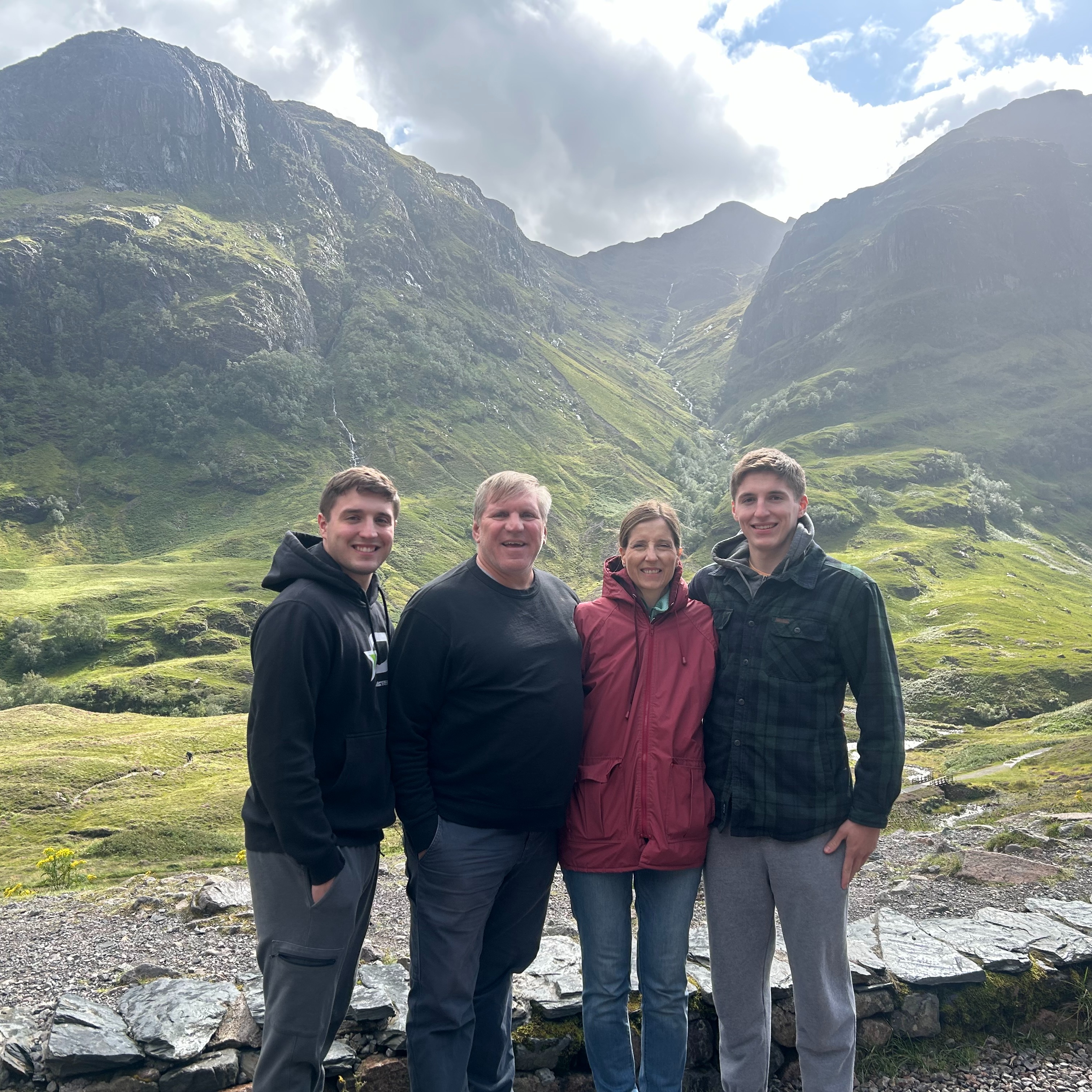 family standing in front of mountains