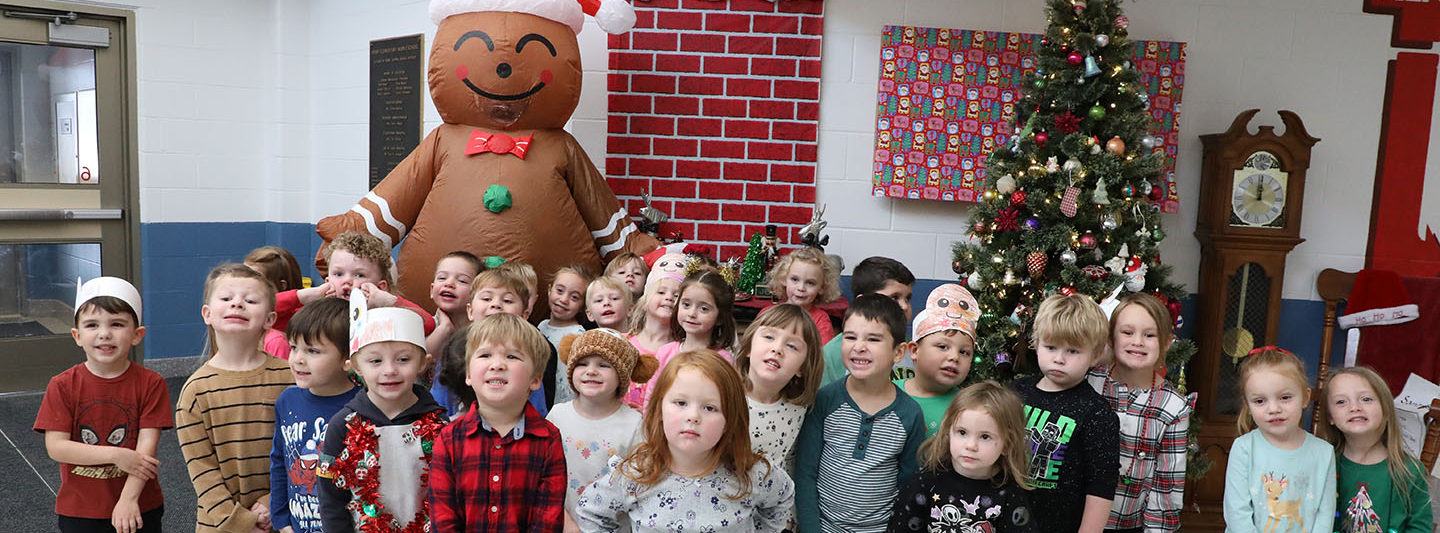 A group of UPK students posing with the Gingerbread Man.