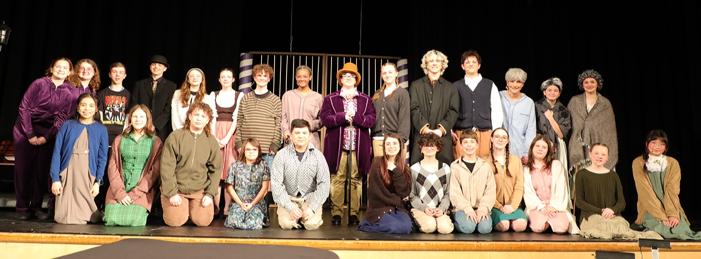 A group of high school kids on a school stage.
