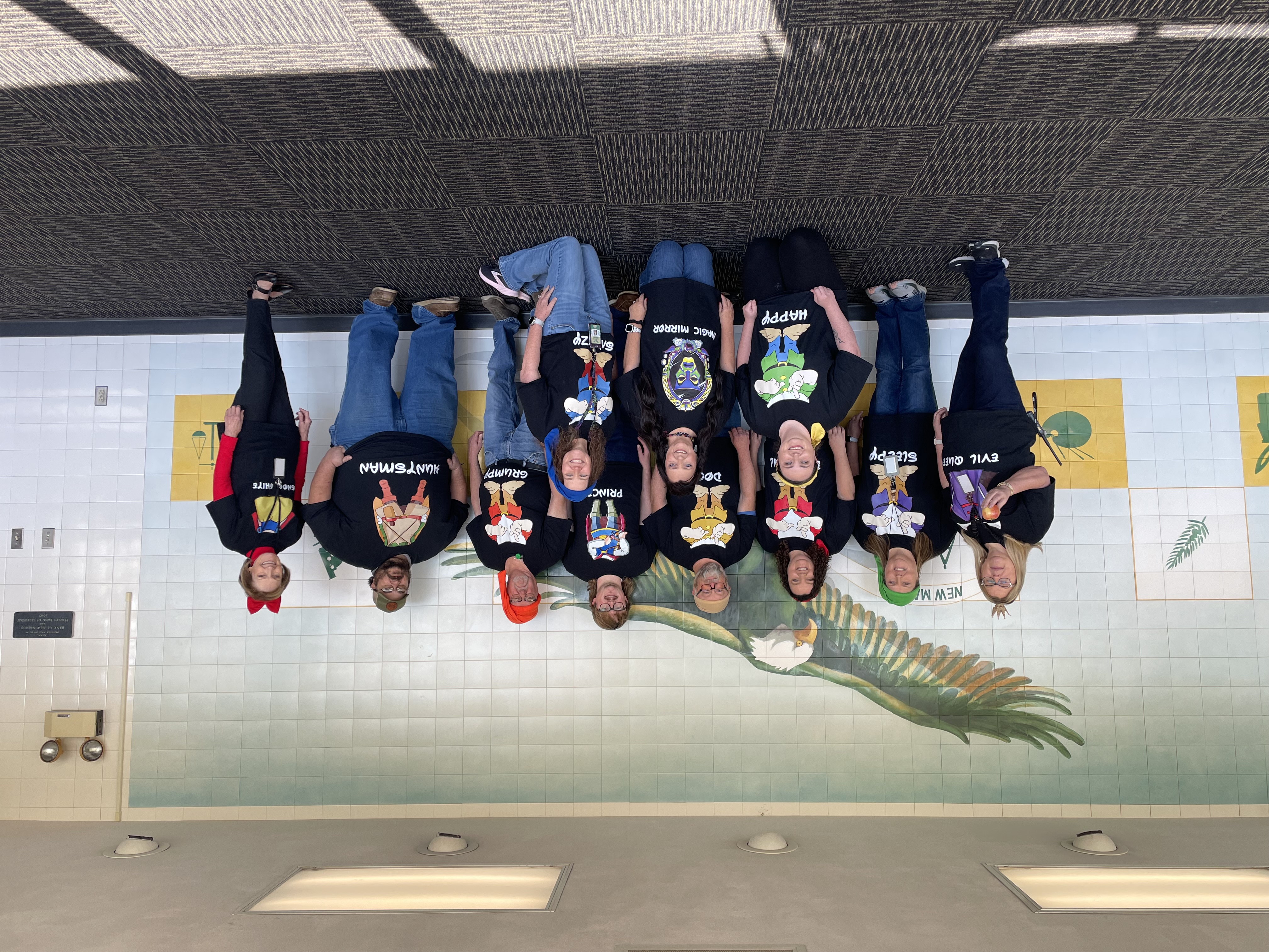 A group of adults "dressed" as Snow White and the Seven Dwarfs.