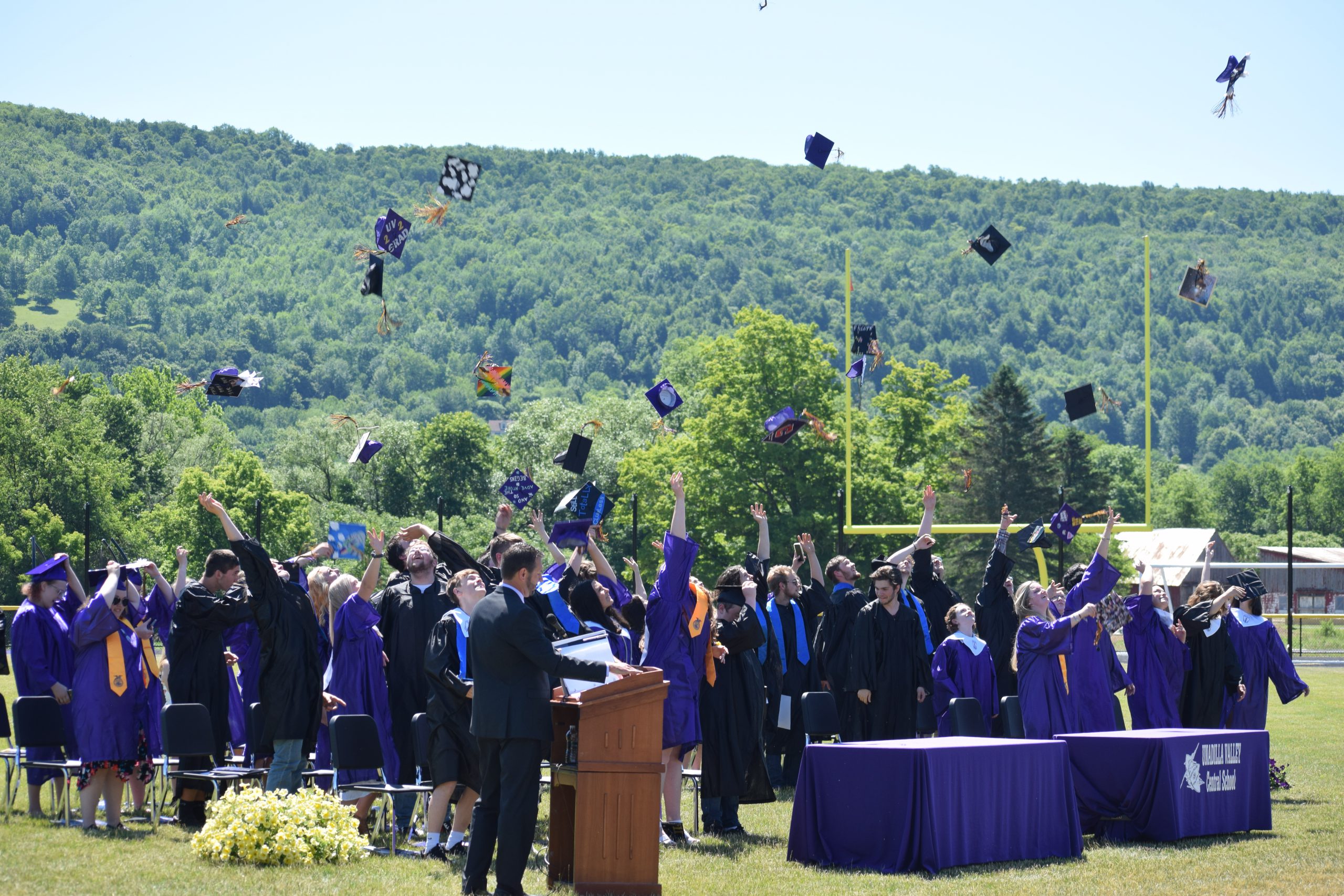 graduating students throwing hats