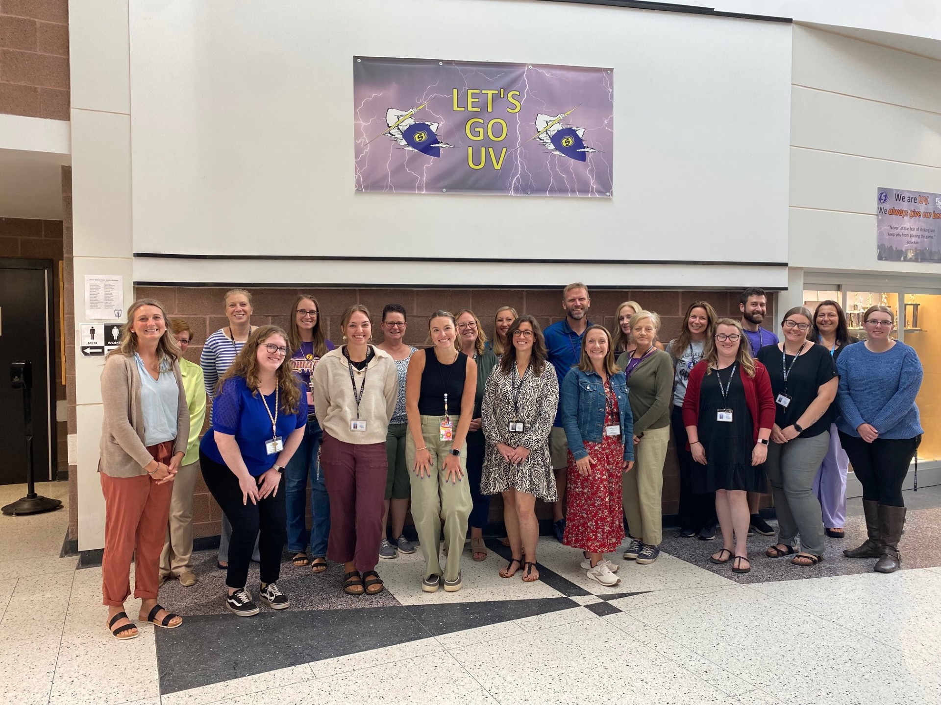 teachers stand in front of a wall