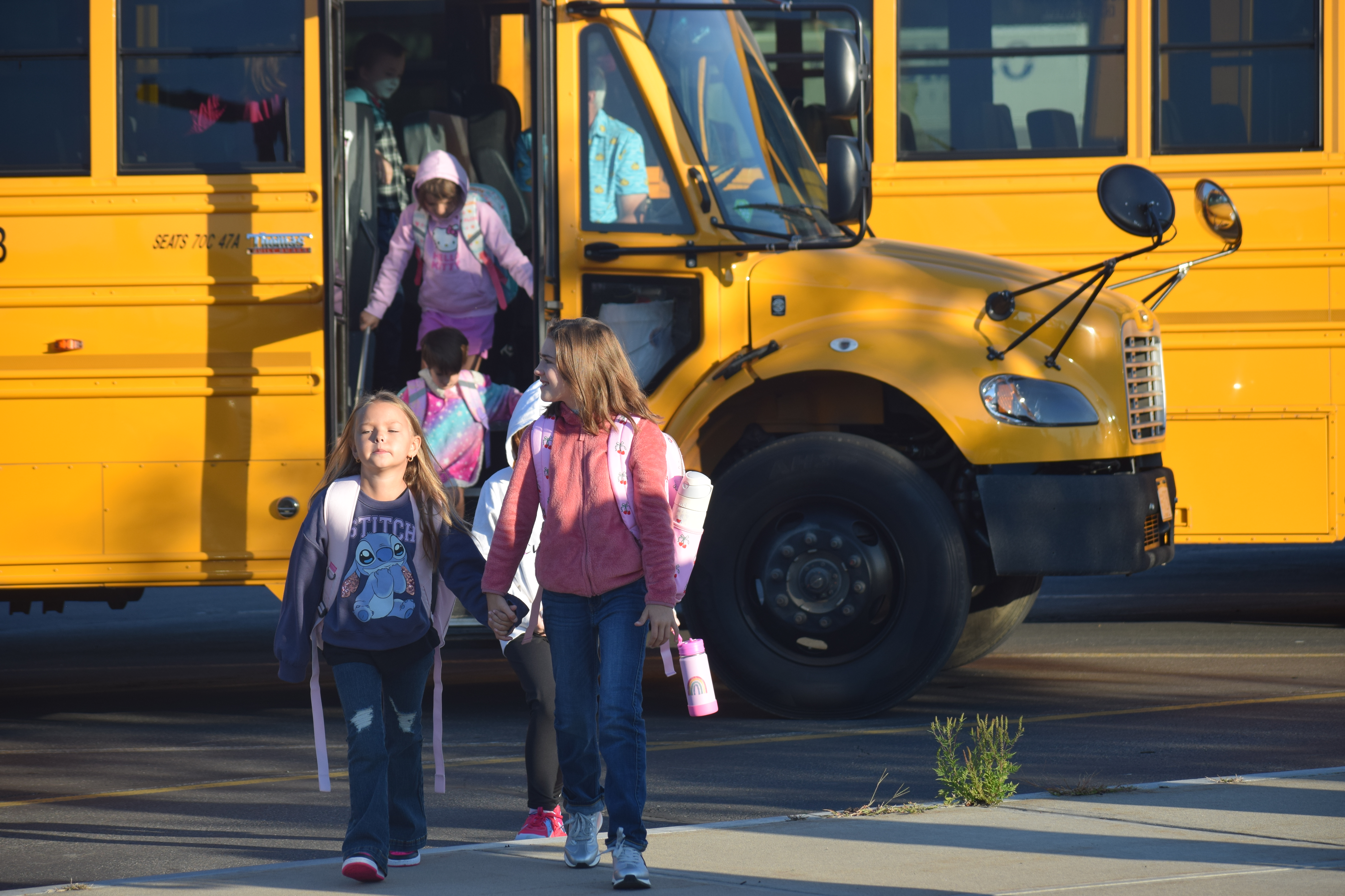 students get off a bus