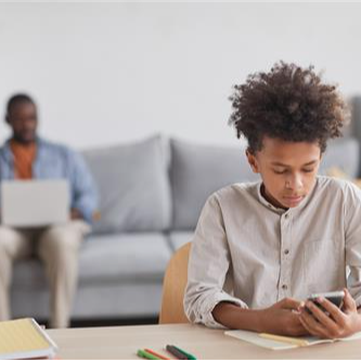 person using phone on a desk