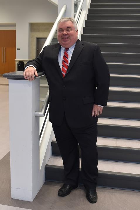 stuart pippin standing on steps wearing a suit