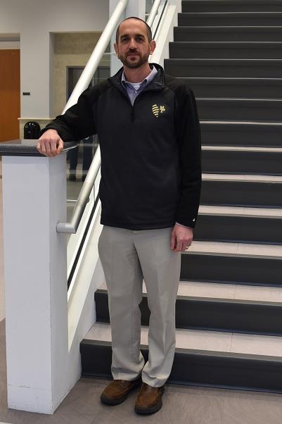 jeremy goodwin standing on steps wearing a black quartzip and khakis