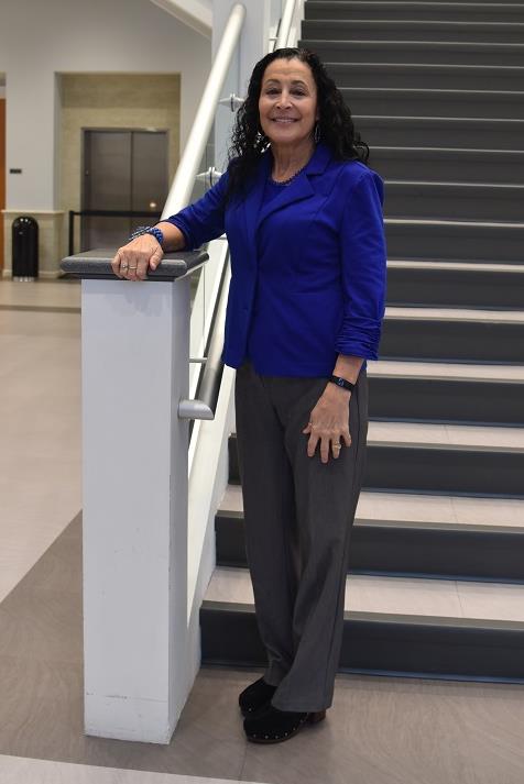 eva bilderback standing on steps wearing a blue blazer