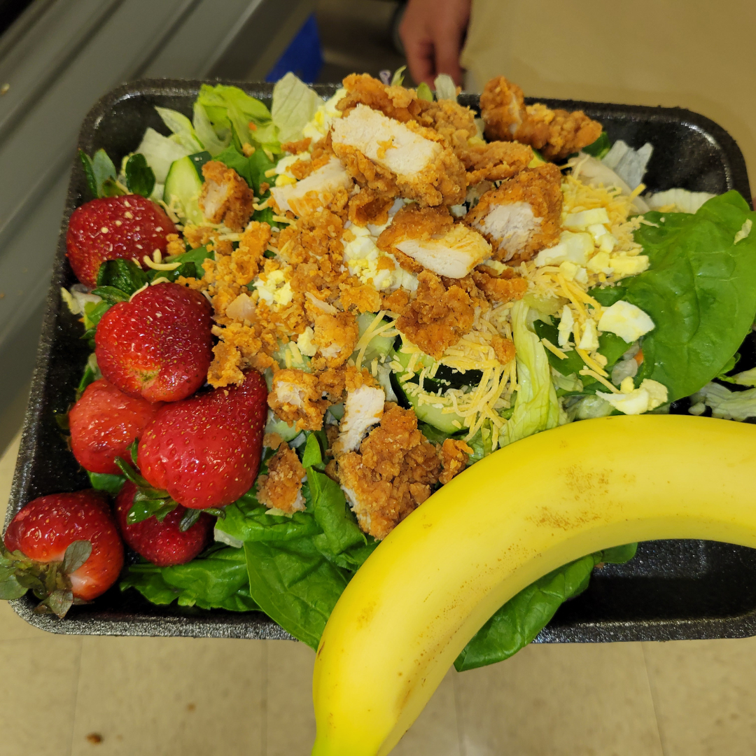 salad with fresh strawberries and a banana