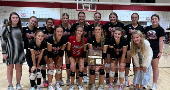 This is a picture of the Varsity Volleyball team and their Regional Championship plaque.