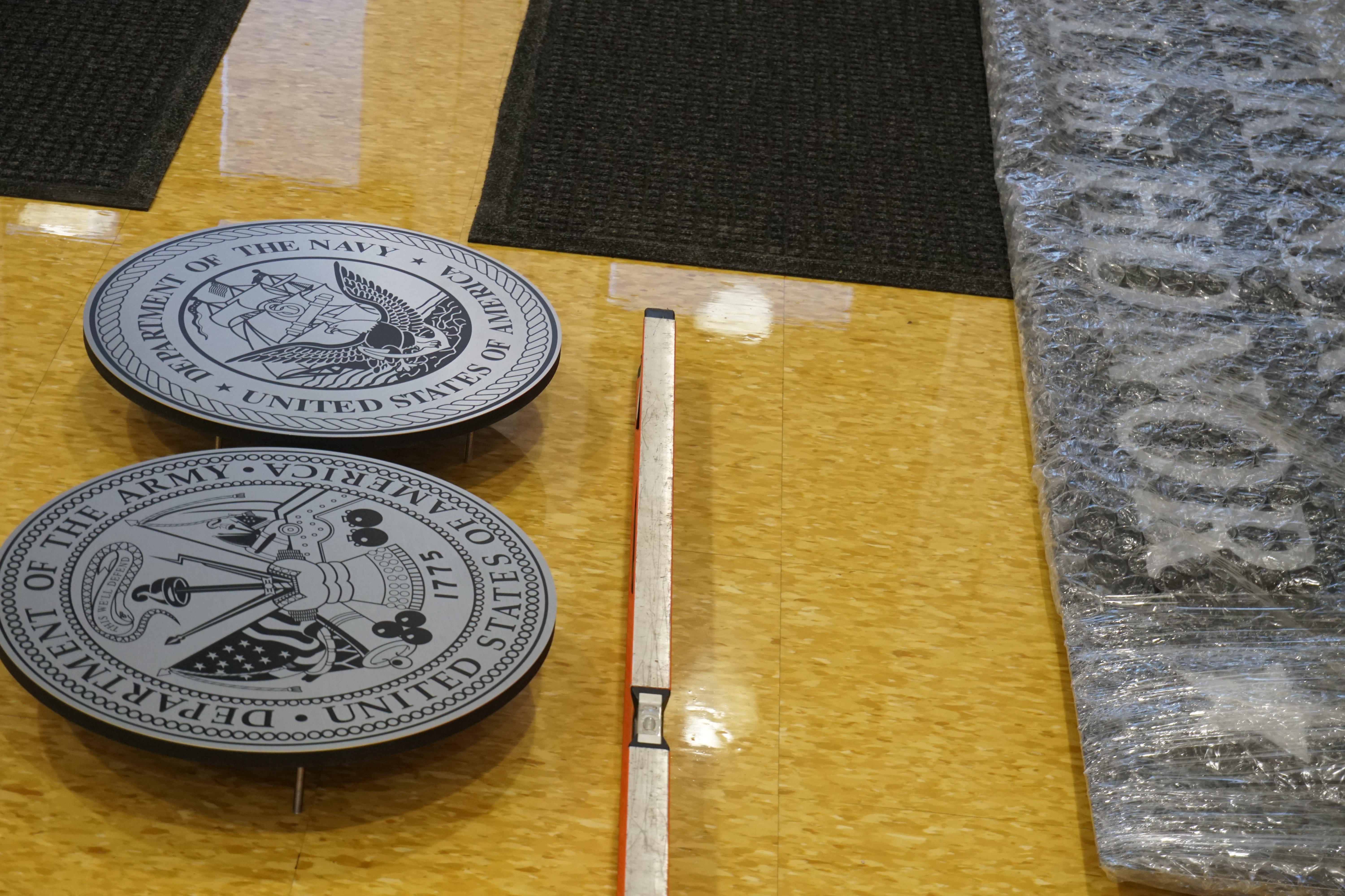 Army and Navy emblem laid on floor planning for installation on the wall