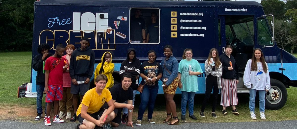 MCAC students posing in front of the Momentum Ice Cream Truck