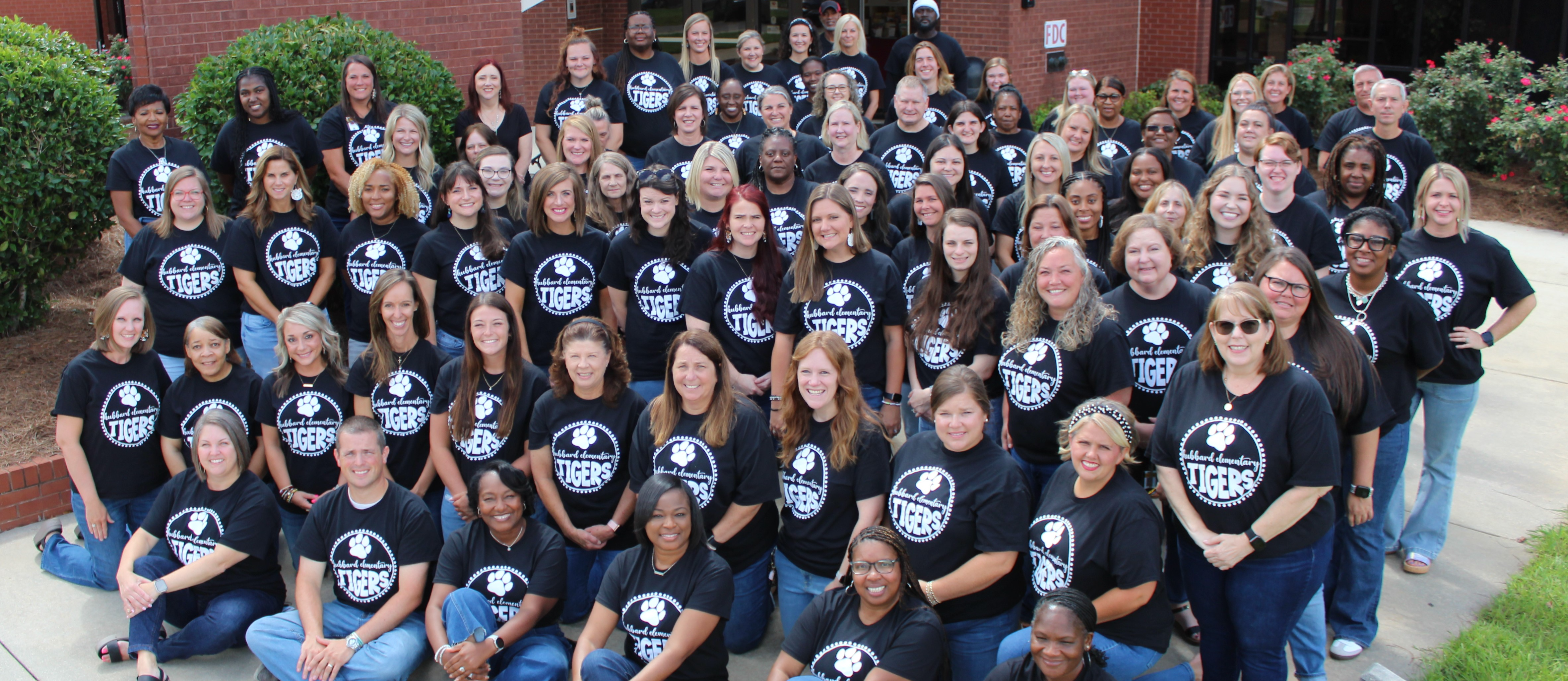 Hubbard staff photo in front of school