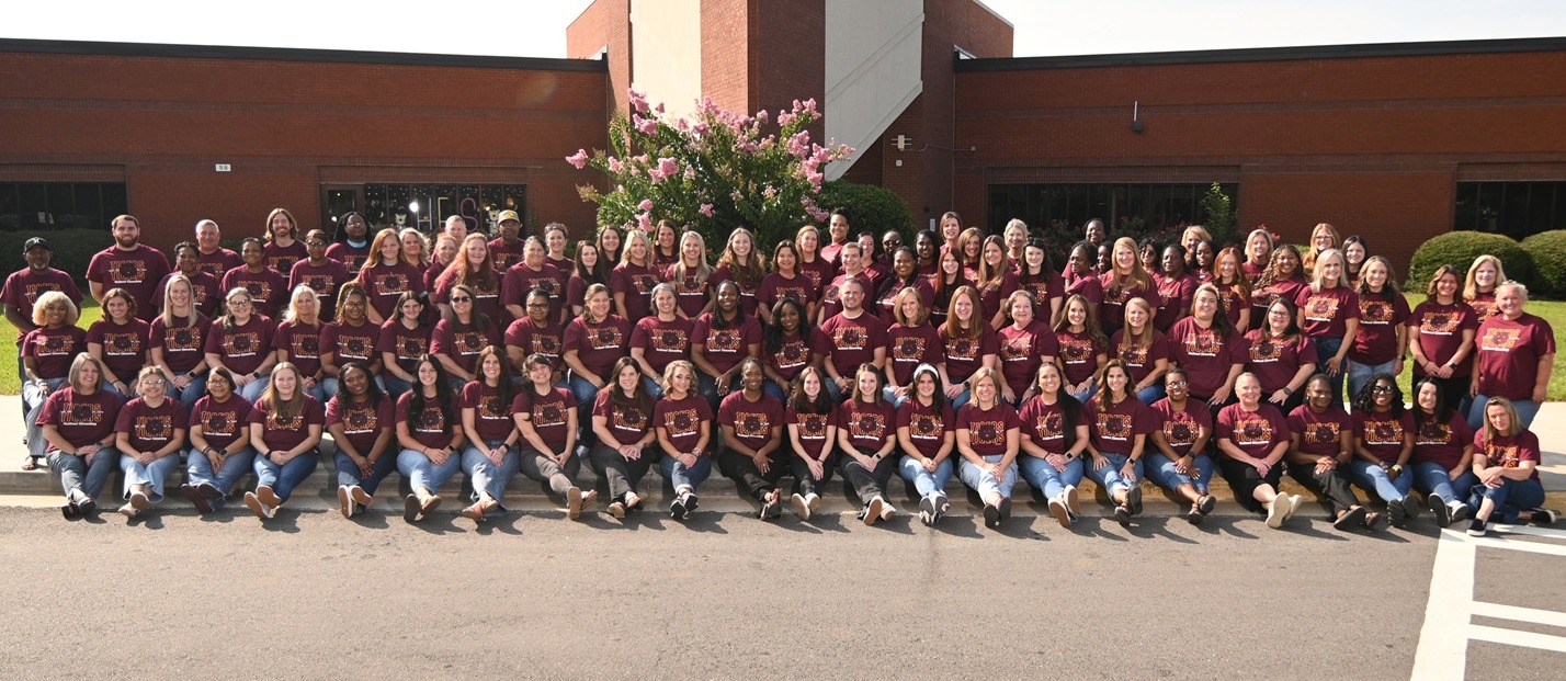 Hubbard staff photo in front of school