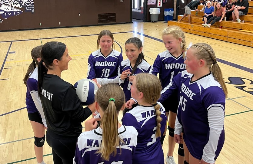 Volleyball huddle with coach