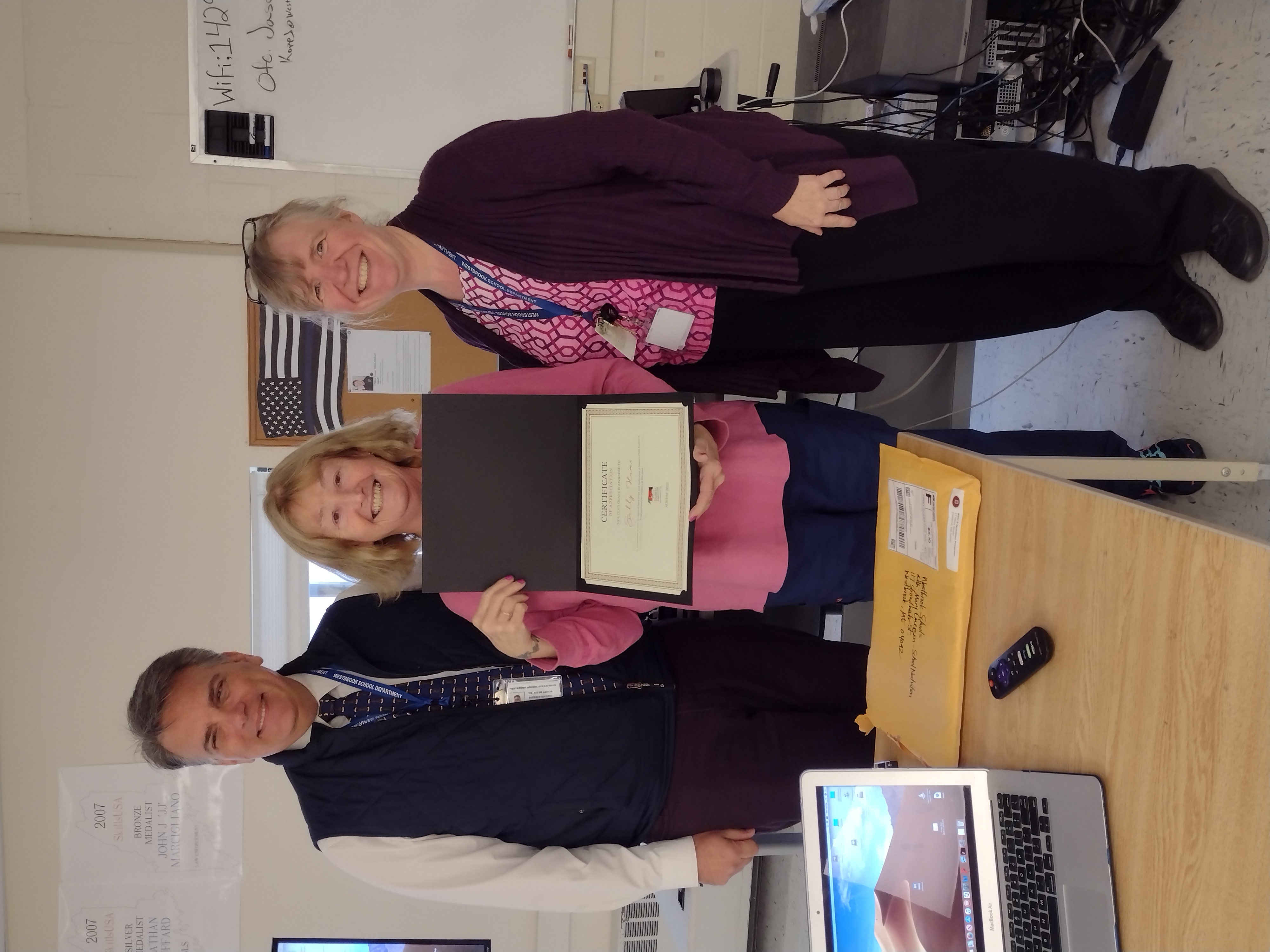 Dr. Lancia presenting 25 years of service to Sally Hume