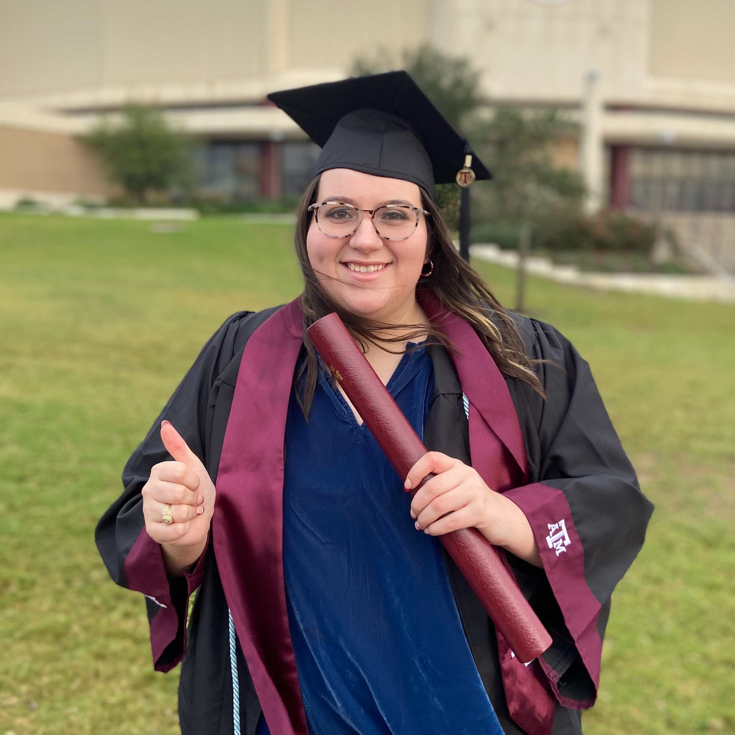 Image of Alexis McDonald in cap and gown from graduation day at Texas A&M