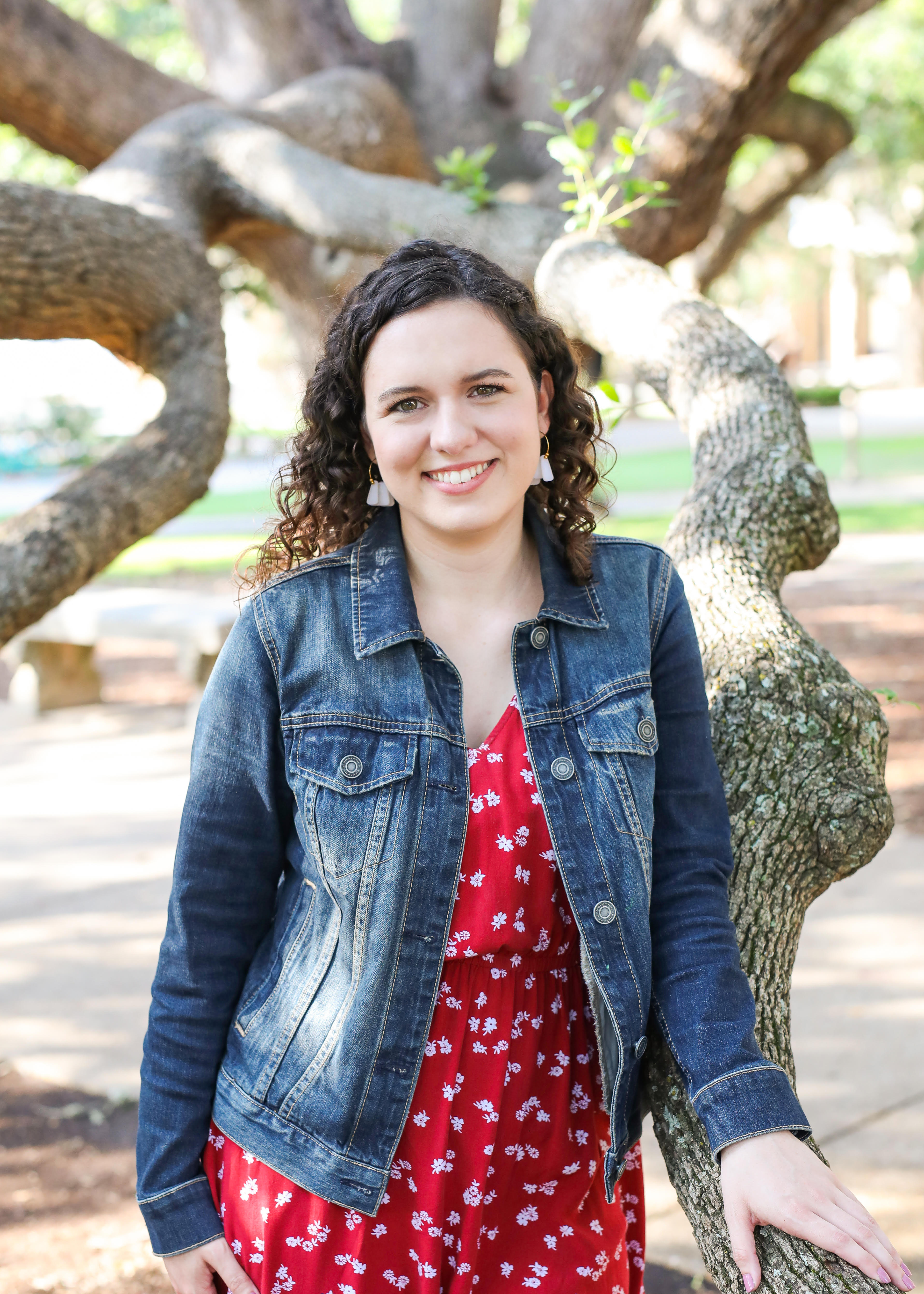 Image of Bethany Belote in red dress and denim jacket