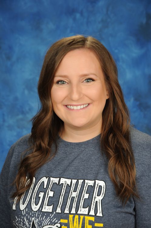 photo of Amy Gryzmala wearing a blue Rayburn shirt on a blue background