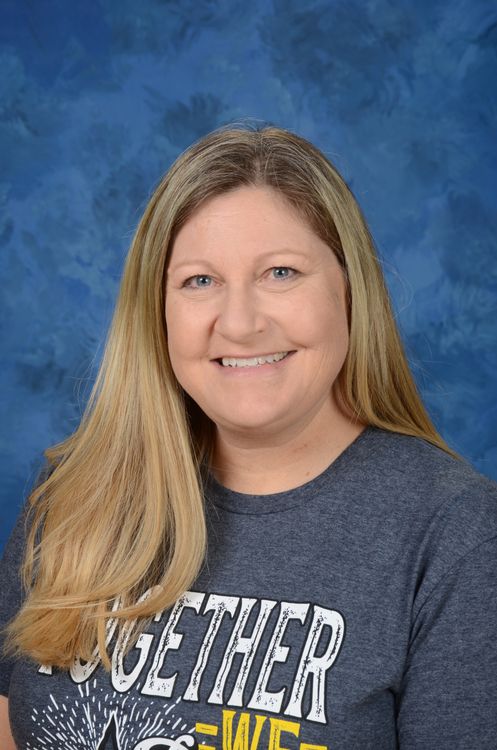 erin neal wearing a dark gray tshirt and a blue background