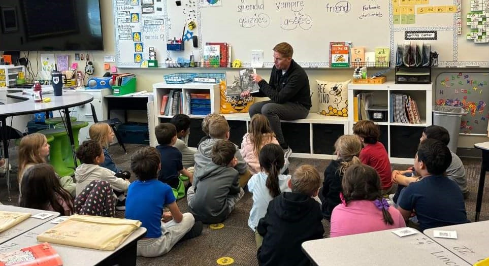 Principal Reading to Students in Class