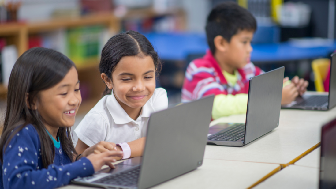 two students accessing the computer together