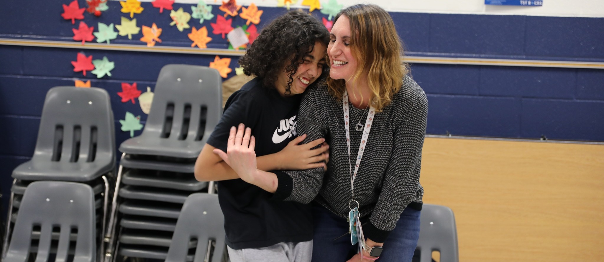 student hugging teacher at a dance