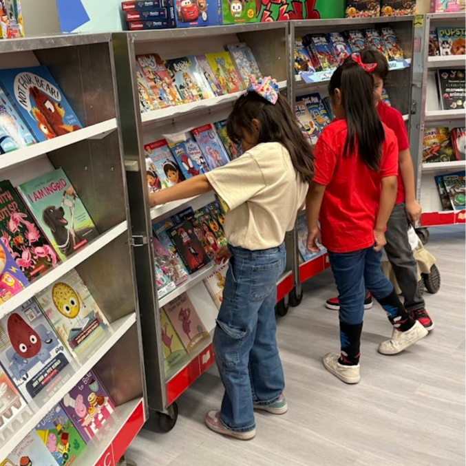 students browsing the books on the carts at the book fair