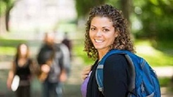 student with backpack smiling for photo 