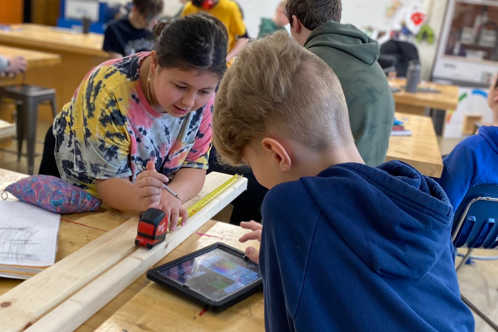 A Student and Teacher Doing an Activity with the STEM Academy