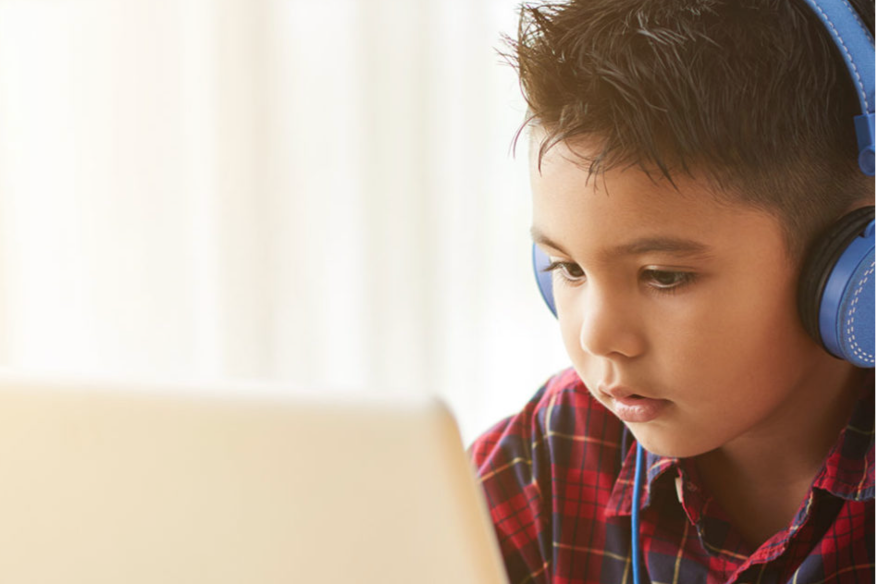A Student with Headphones Participating in the e-Achieve Academy