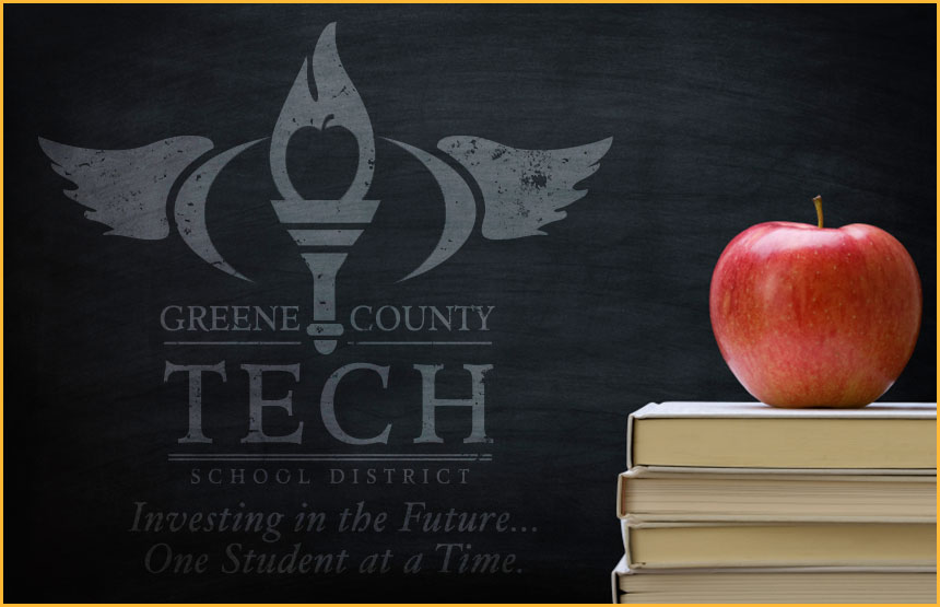 Pile of books with a red apple on top and blackboard on the back