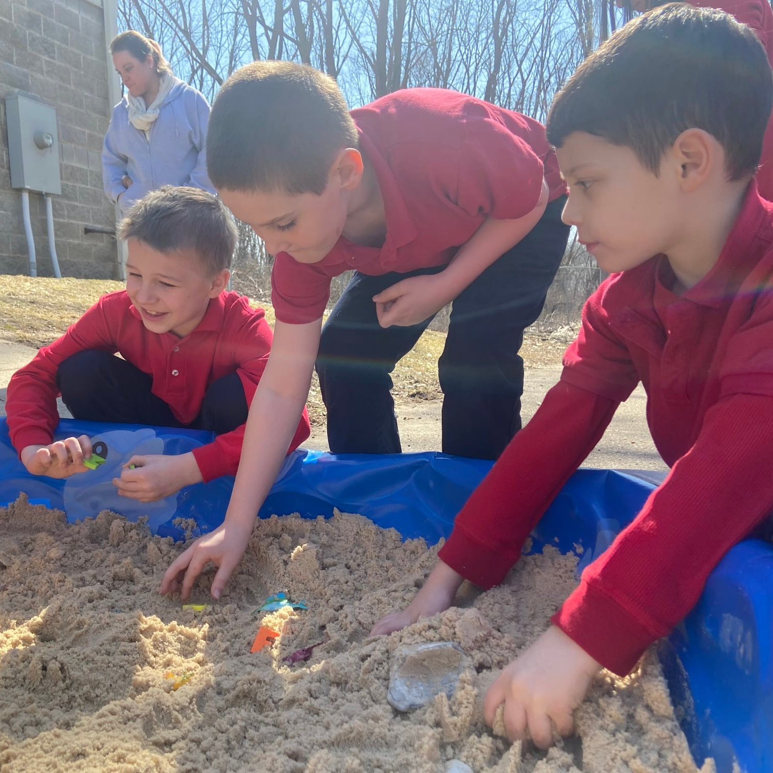 students play in sandbox on playground together